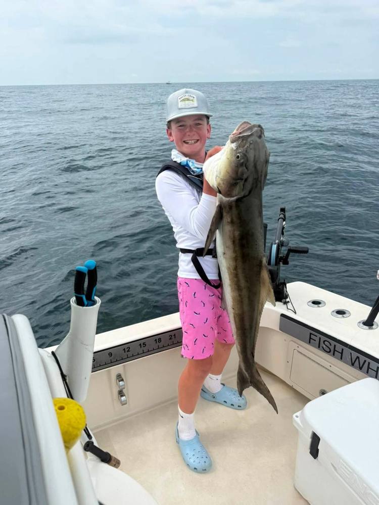 Advanced camper holding an amberjack offshore