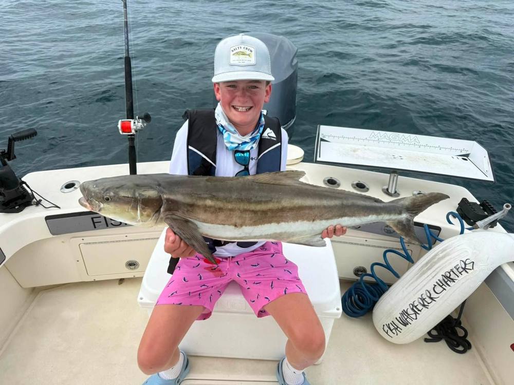Advanced camper holding a cobia offshore