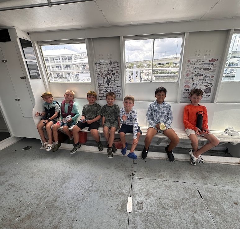 Seven campers on the bench inside the air-conditioned cabin of the head boat Kokomo