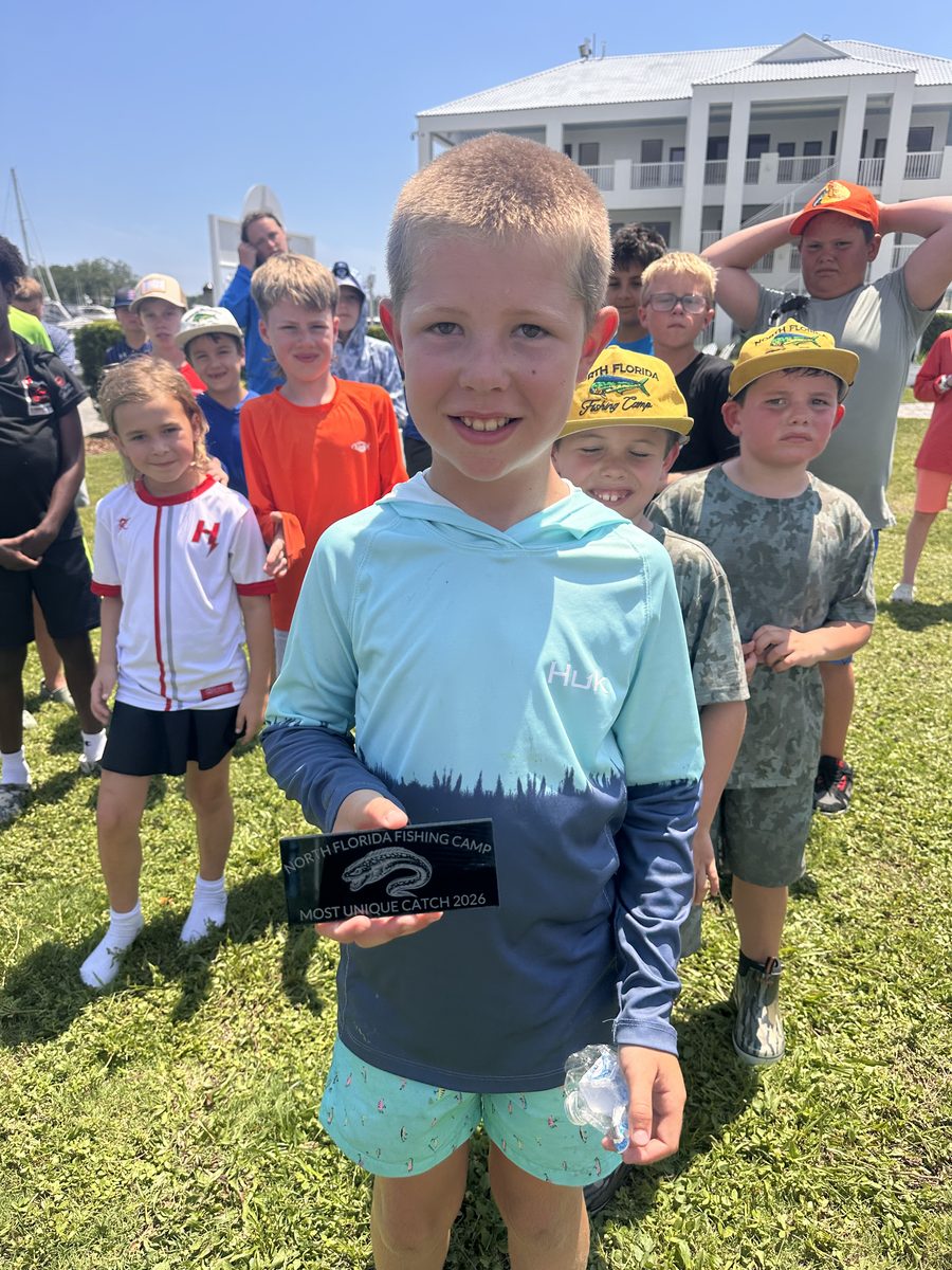 Camper holding his Most Unique Catch plaque at the Friday awards
