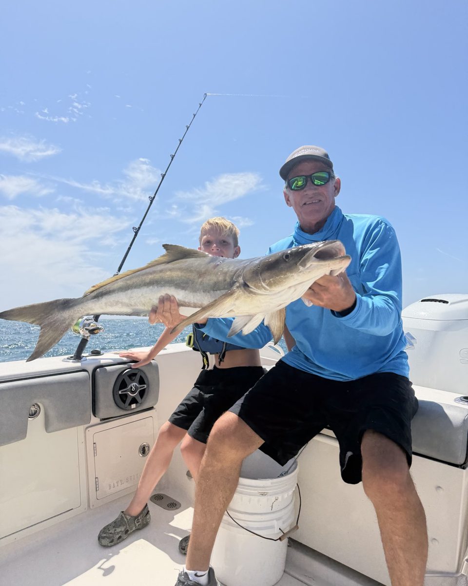 Capt. Don Dingman holding a kingfish on the boat
