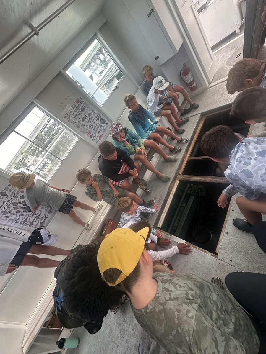 Joe teaching campers in the engine room of the head boat