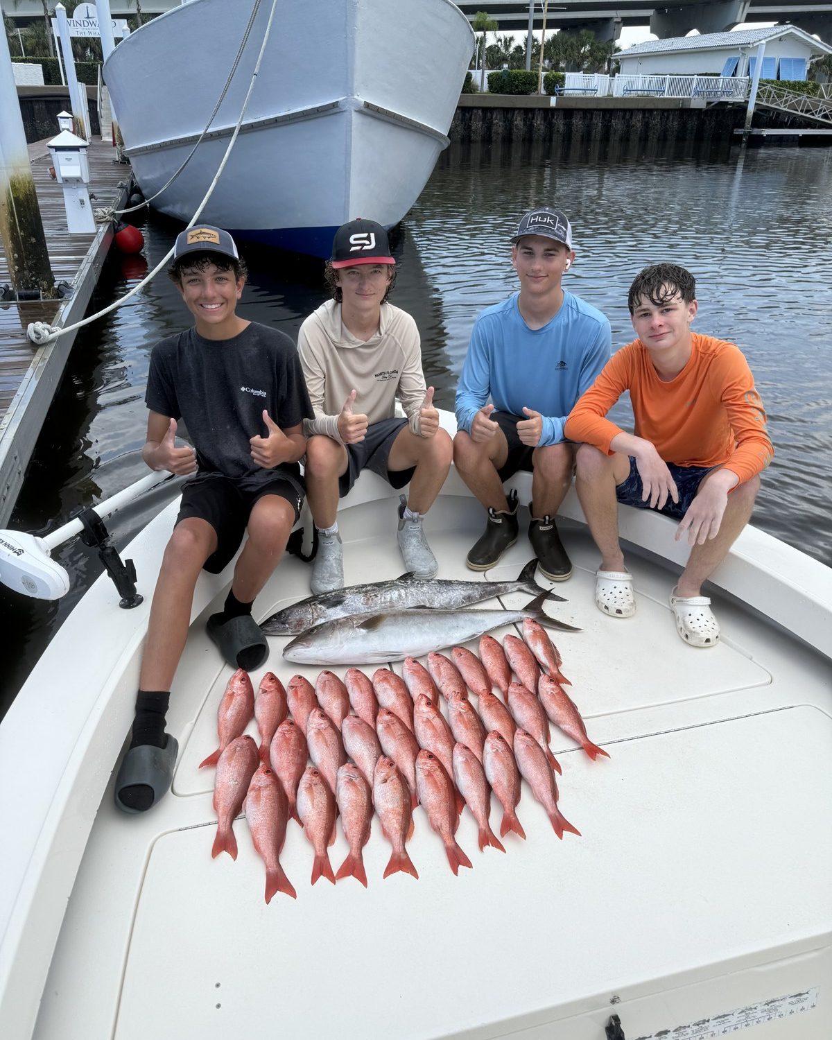 Advanced campers with the day's catch laid out on the boat