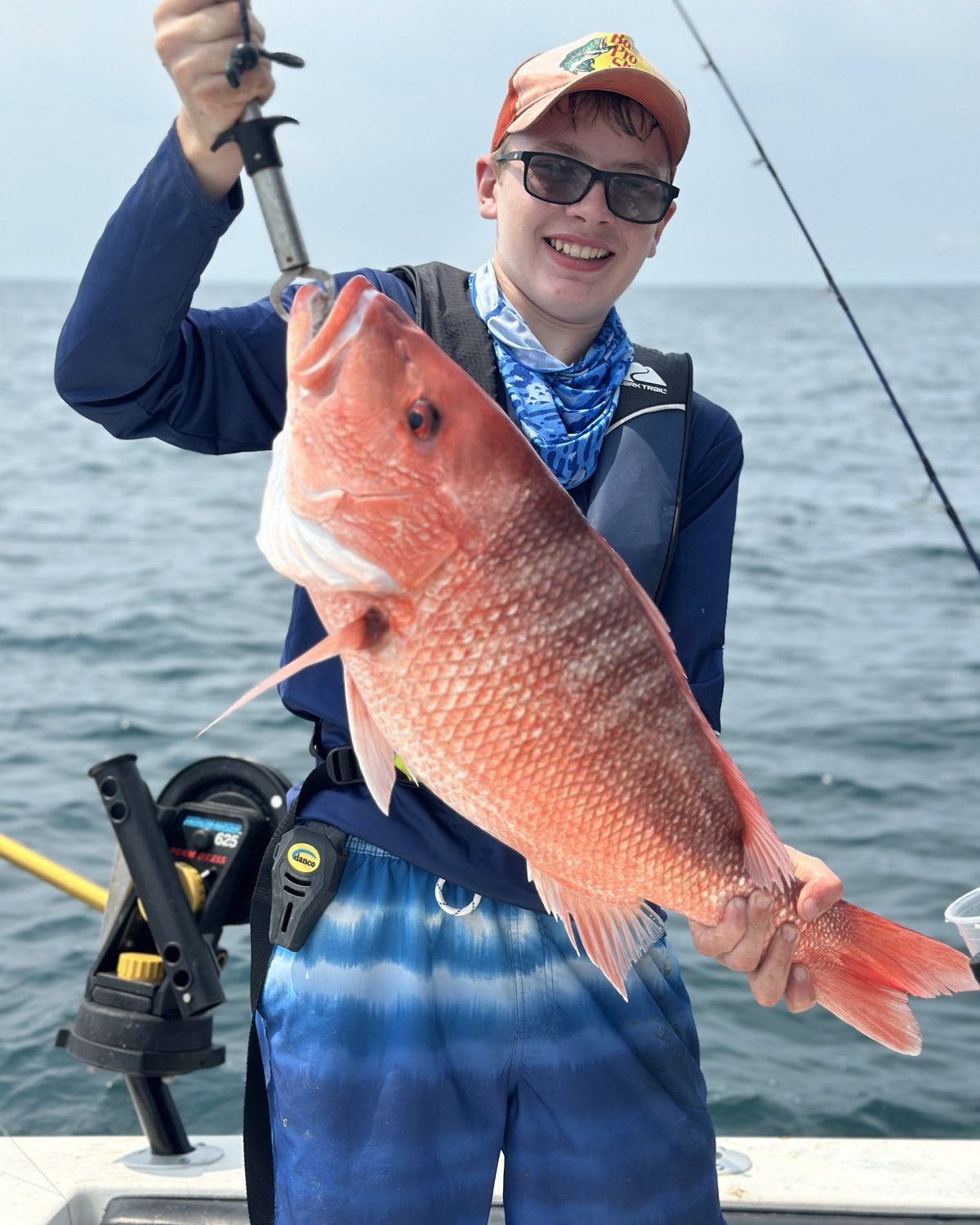 Advanced camper holding a red snapper