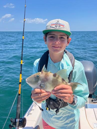 Camper holding a triggerfish