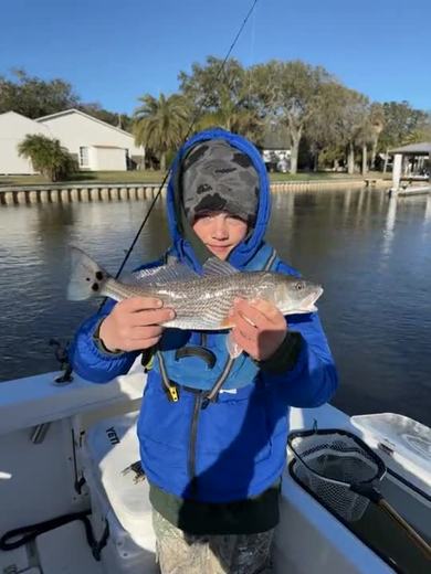 Camper holding a speckled trout
