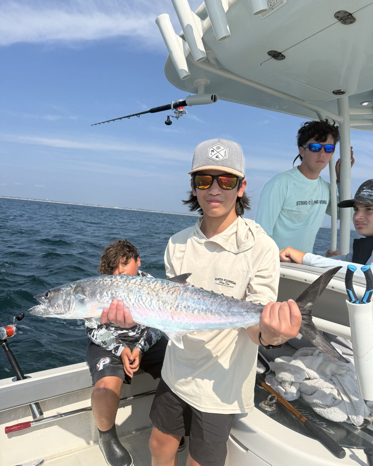 Camper holding a kingfish on the offshore day