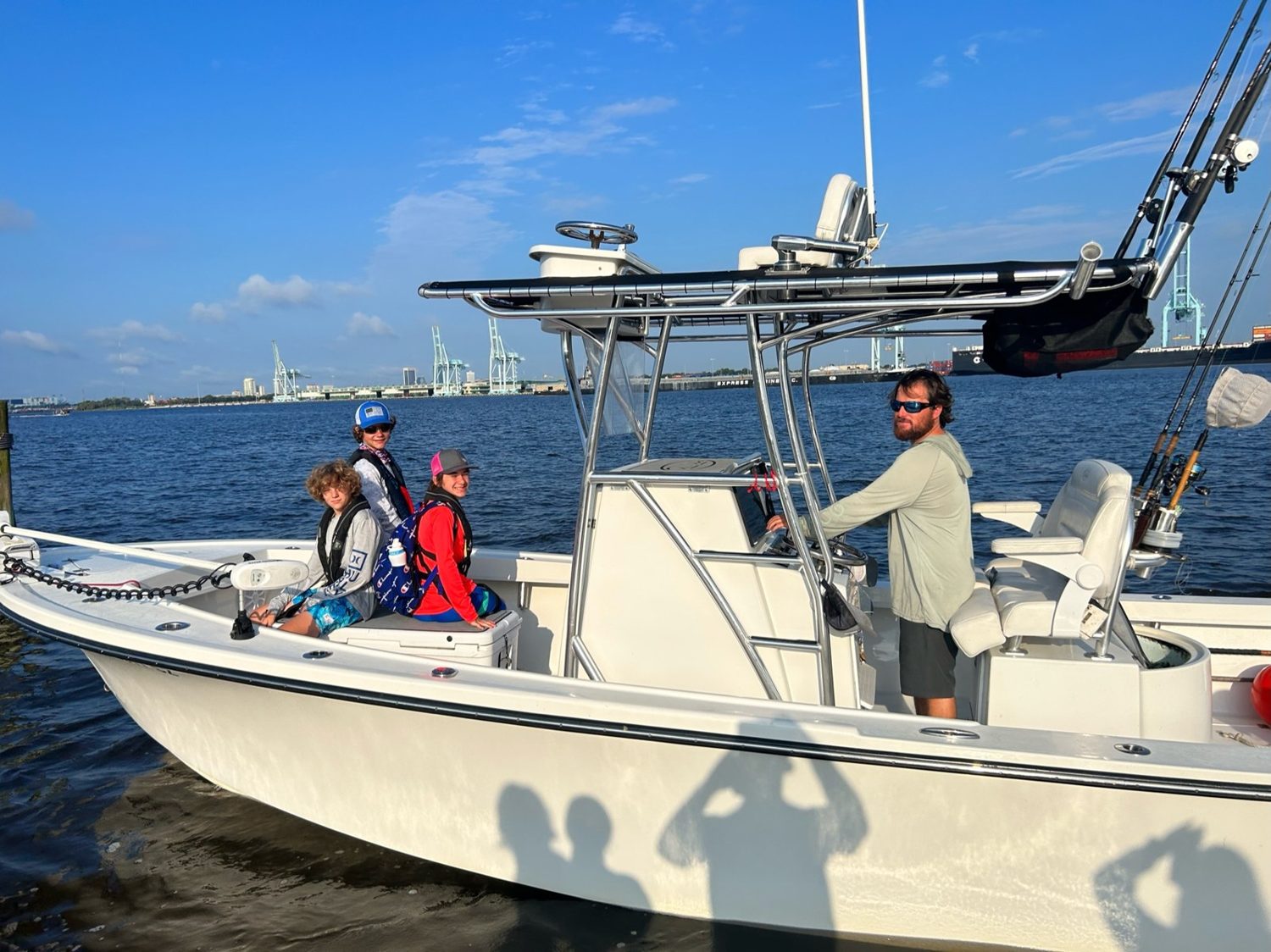 Charter boat with campers on the St. Johns River, Jacksonville skyline behind