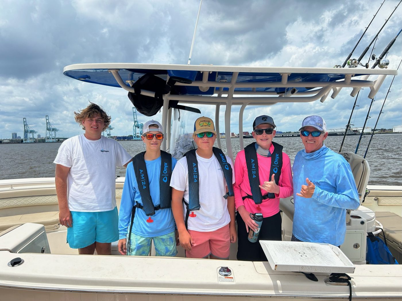 Overnight campers and their captain aboard a charter boat at the Jacksonville University dock