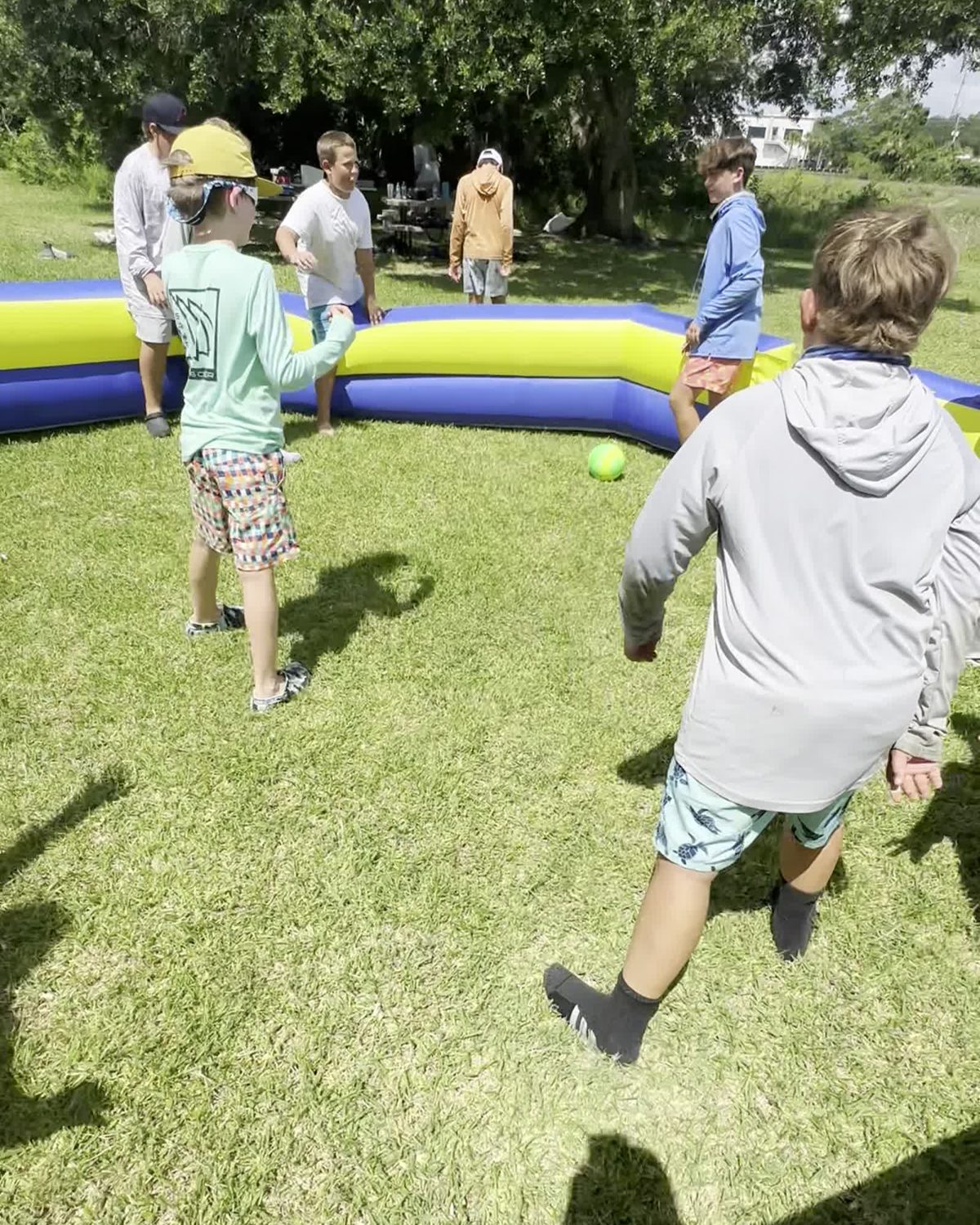 Campers playing gaga ball on campus in the evening