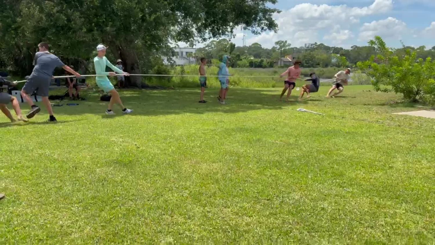 Campers playing tug of war on the field at Jacksonville University