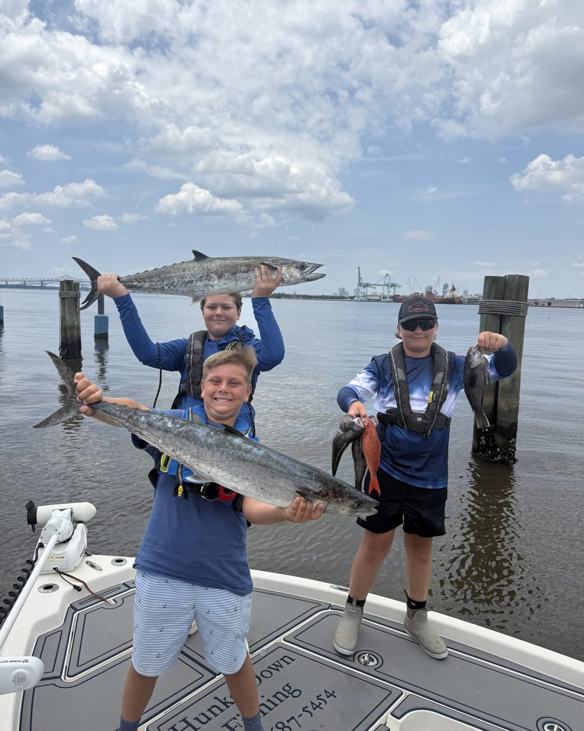 Two campers with a barracuda on the boat