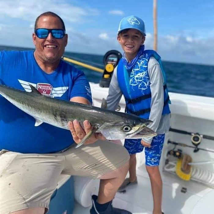 Camper and captain with a kingfish